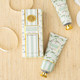 Flat lay of magnolia fig hand cream with botanical-inspired packaging and matching tube detail