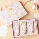 Flat lay of sweetheart blooms hand cream trio with pastel floral designs and gift-ready box