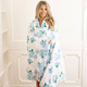 Woman wearing hydrangea floral throw blanket showing soft drape and cozy fit