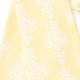 Close-up of golden damask kitchen towel fabric with soft yellow tone and detailed pattern