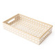 Rectangular tan cane tray with woven texture and raised edges for vanity or home organization (angled view)