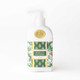 Woodland Cranberry hand & body lotion pump bottle with a green holly and berry print label (styled detail view)