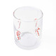 Clear drinking glass with candy cane bead icons, filled with a festive holiday drink (close-up view)