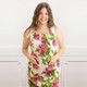 Woman wearing the Pomegranate Grove cotton kitchen apron with a pink pomegranate print