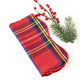 Red tartan plaid cotton dinner napkin tied with a red ribbon (close-up view)