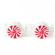 Two ceramic salt and pepper shakers shaped like wrapped peppermint candies with red swirl centers