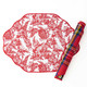 Reversible placemat with a red nutcracker toile print on one side and red tartan plaid on the other