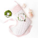 Blush pink quilted Christmas stocking with a velvet cuff, wreath, and nutcracker embroidery, hung on a mantel (alternate angle)