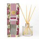 Pomegranate & Oud reed diffuser with a glass vessel, gold collar, and reeds in a striped gift box