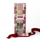 Pomegranate & Oud reed diffuser with a glass vessel, gold collar, and reeds in a striped gift box (alternate angle)