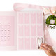 Sugarplum Gingham hand cream advent calendar open to show 12 numbered slots holding assorted mini hand cream tubes (shown in a styled setting)