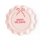 Blush pink ceramic dessert plate with 'Happy Holidays' lettering and a peppermint bow