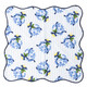 Holiday Chinoiserie scalloped dinner napkin with a blue floral and bow print (close-up view)