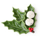 Glossy green ceramic dessert plate shaped like a holly leaf with a red berry cluster accent