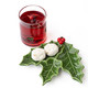 Glossy green ceramic dessert plate shaped like a holly leaf with a red berry cluster accent (shown in a styled setting)