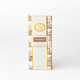 Gingerbread hand cream box and tube in a tan and gold gingerbread-house print (alternate angle)