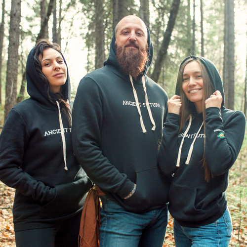 Organic fleece hoodie worn by two women and one man in forest setting