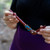 Rosewood tepi applicator held in hand