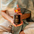 Rose hydrosol bottle held in hand