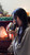 Woman drinking ceremonial cacao from handmade mug with candle and salt lamp in background
