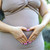 Woman placing hands over lower abdomen
