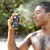 Man spraying Agua del Aguila spray on body