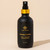 Munay healing lotion in black bottle on beige background