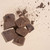 Criollo Mexican ceremonial cacao chunks on beige background