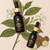 Nukini Sananga eyedrop bottles displayed with sananga shrub and flower