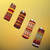 Beaded lighter covers in red tones on four lighters