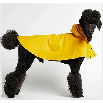 Side view of William Yellow Waterproof Dog Rain Cape with black dog standing