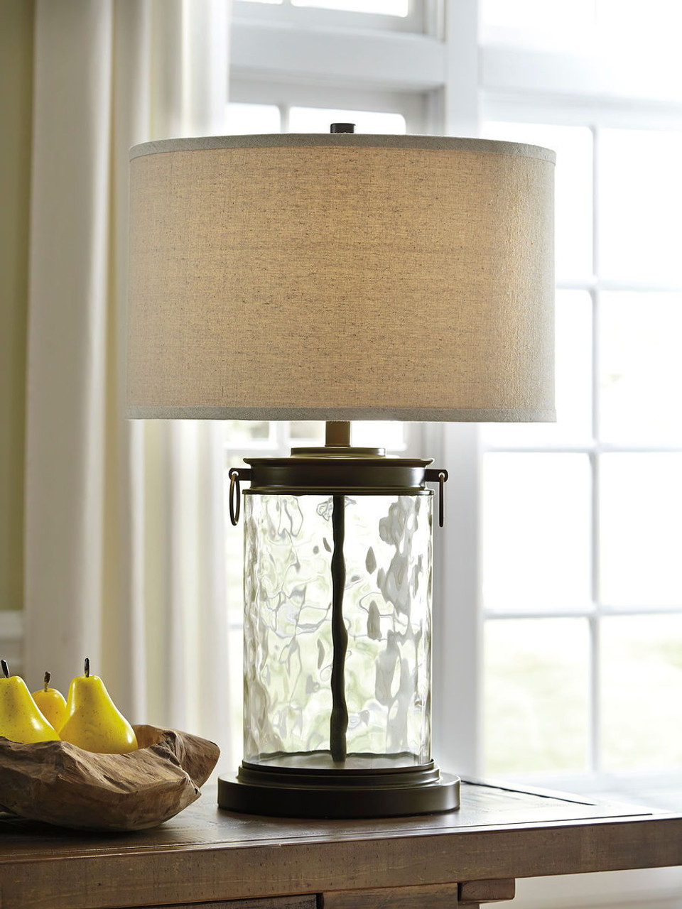 The Tailynn Clear/Bronze Finish Glass Table Lamp is available at