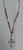 33" Asymmetrical hammered cross necklace.
Made of maroon jade, metal, and crystal beads. 
Handmade in Texas by Carol Su.