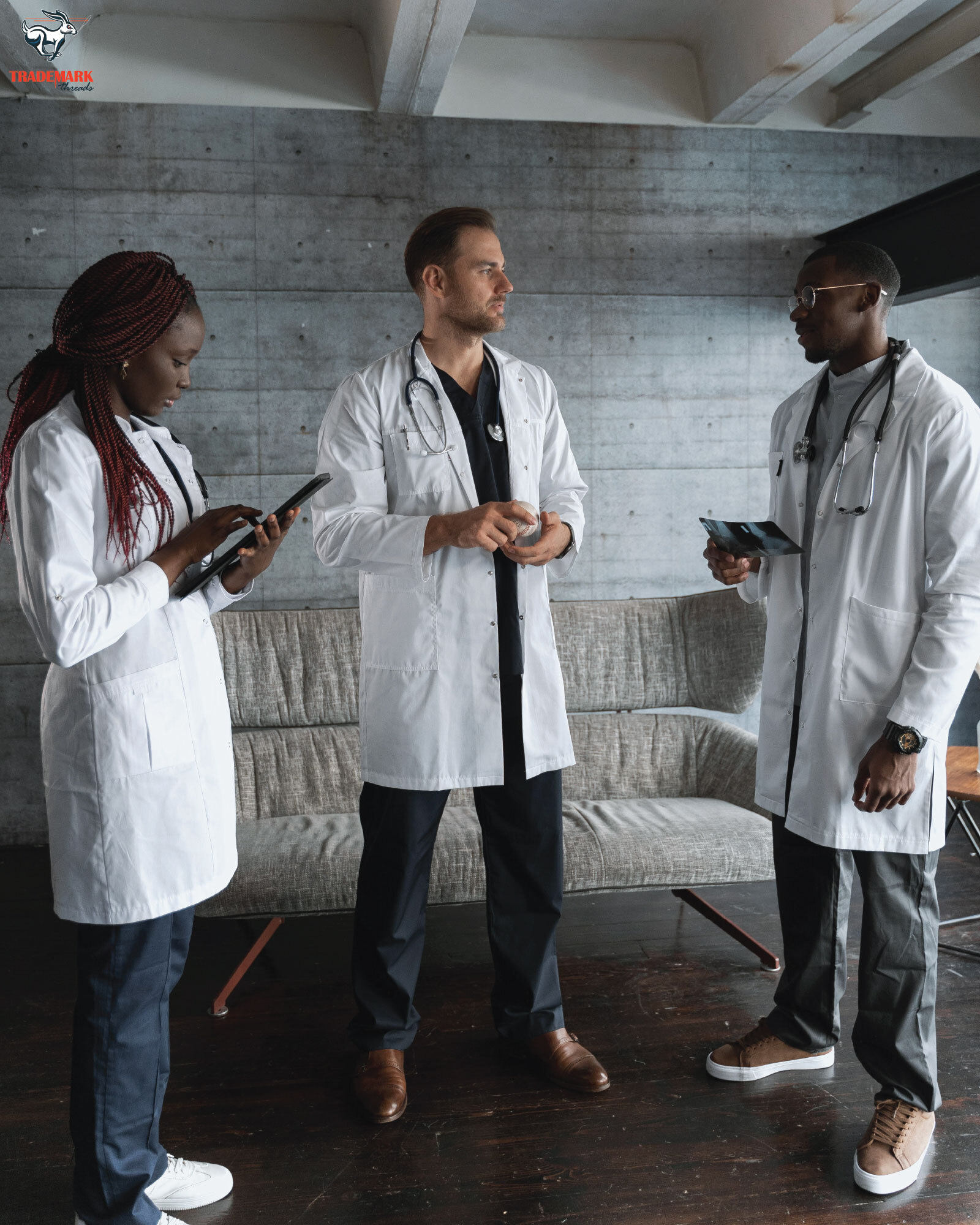 Team portrait in coordinated branded apparel against a dark studio background