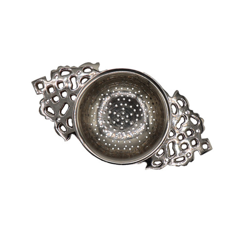 top view of metal tea strainer that sits on top of cup