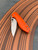The Spyderco Positron Knife Center Exclusive in orange polished G10 with an S35VN blade.
