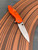 The Spyderco Positron Knife Center Exclusive in orange polished G10 with an S35VN blade.