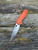 The Spyderco Positron Knife Center Exclusive in orange polished G10 with an S35VN blade.