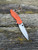 The Spyderco Positron Knife Center Exclusive in orange polished G10 with an S35VN blade.