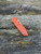 The Spyderco Positron Knife Center Exclusive in orange polished G10 with an S35VN blade.