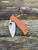 The Spyderco Sage 5 in REX 121 steel and  burnt orange coloured G10 handle scales.
