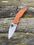 The Spyderco Sage 5 in REX 121 steel and  burnt orange coloured G10 handle scales.