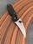 The Spyderco P'Kal™ resplendent on leather background.