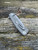 Hinderer Project X Magnacut with horse head engraved titanium scale.