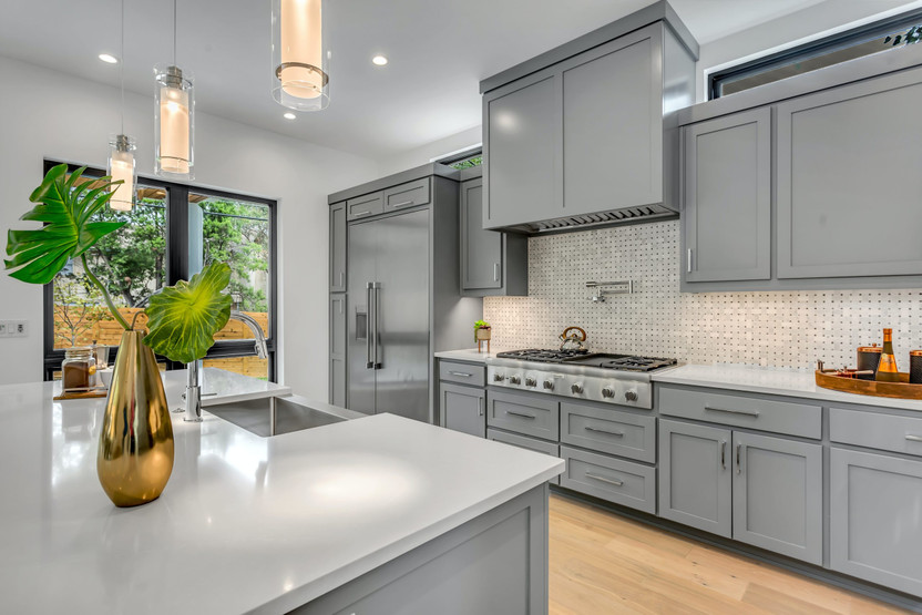 white kitchen cabinets with grey countertops