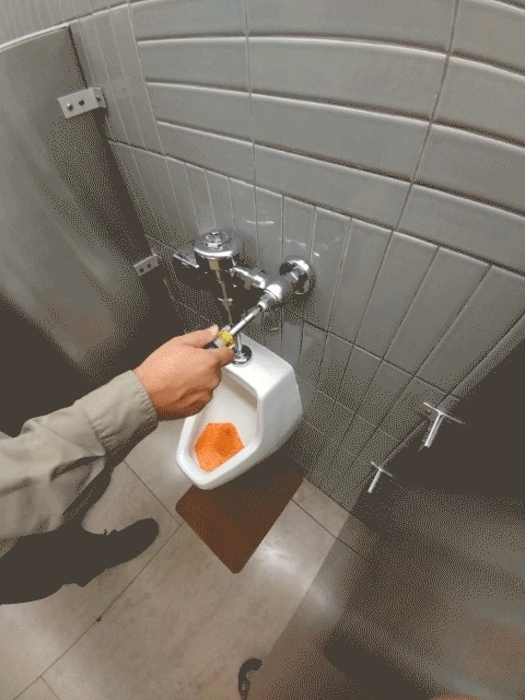 JaniWrap being applied to a urinal
