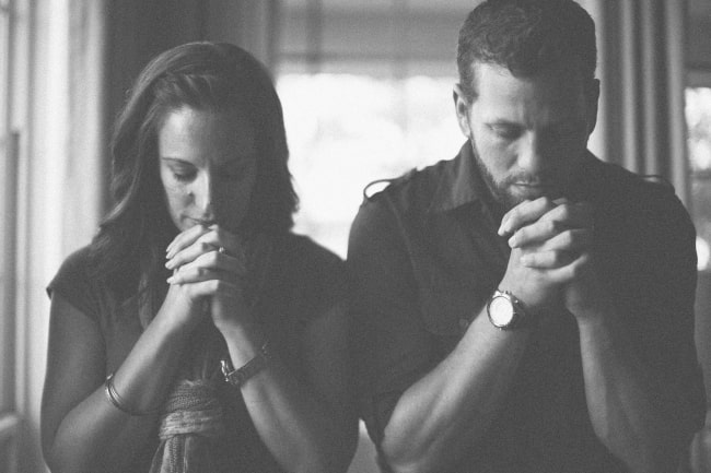 Husband and wife praying together