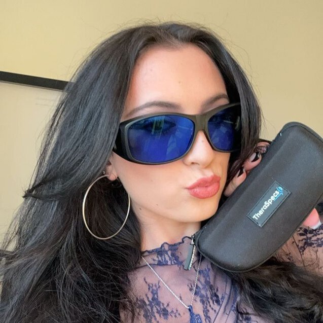 Ginny wearing Z-Blue TheraSpecs in fitover frame