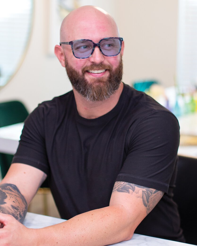 Man smiling and wearing TheraSpecs Z-Blue glasses for vestibular dizziness and vertigo