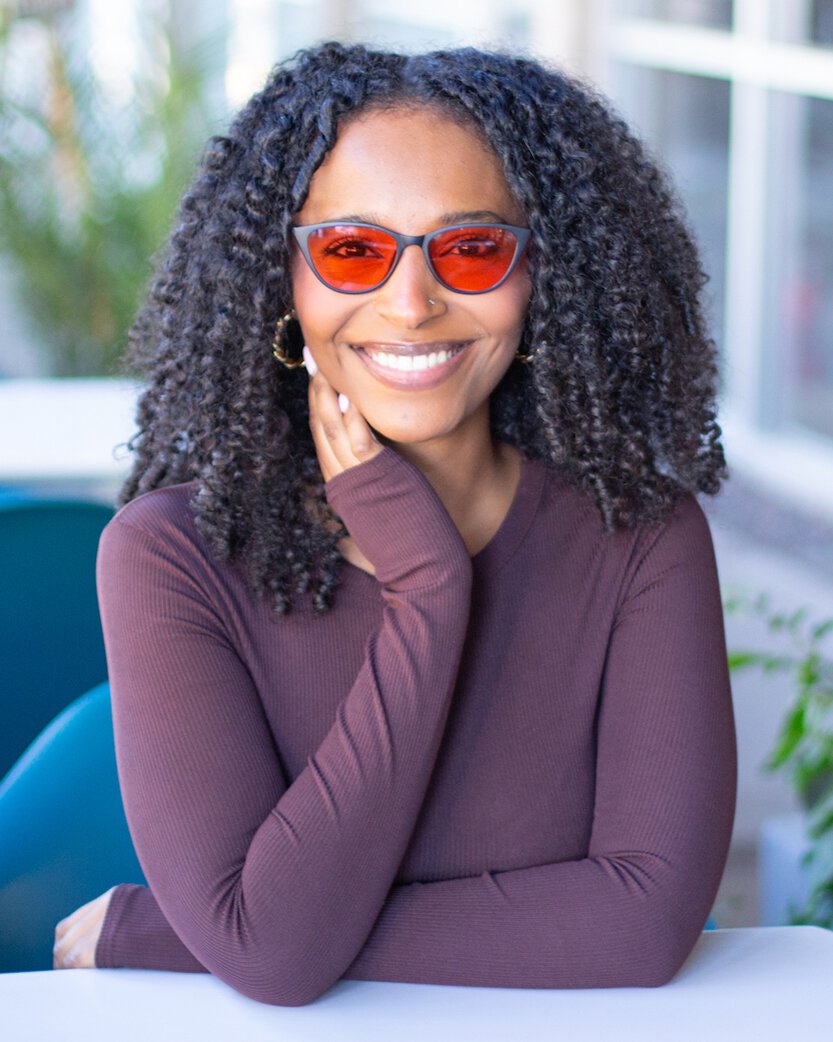 Young woman wearing TheraSpecs therapeutic glasses for LED sensitivity